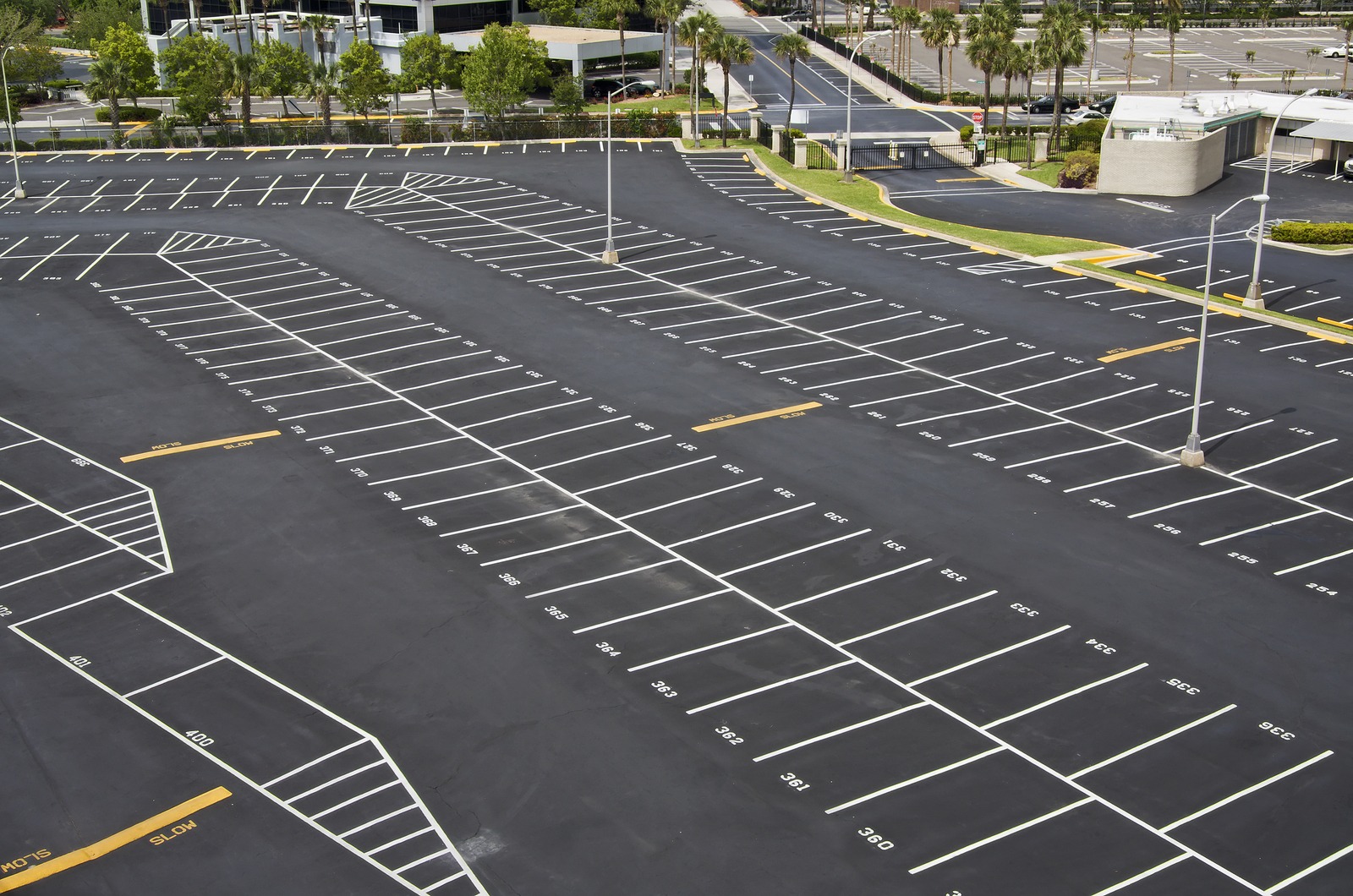Crisp white parking stall lines striped on a large commercial asphalt lot